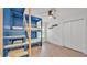 Charming bedroom featuring custom blue bunk beds with built-in ladder and white walls at 2202 Hickory Ridge Dr, Valrico, FL 33596