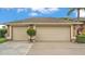 Attached two car garage and driveway with an easy to maintain lawn at 2202 Hickory Ridge Dr, Valrico, FL 33596