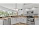 Bright kitchen with granite counters, stainless steel appliances, and a view of the screened patio at 2202 Hickory Ridge Dr, Valrico, FL 33596