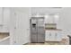 Kitchen featuring white cabinets, granite counters, stainless steel refrigerator and tile floors at 2202 Hickory Ridge Dr, Valrico, FL 33596