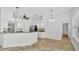 Bright kitchen with white cabinets, granite countertops, stainless appliances, and modern pendant lighting at 2202 Hickory Ridge Dr, Valrico, FL 33596