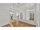 Open-concept living space featuring hardwood floors, high ceilings, and views into the kitchen at 2202 Hickory Ridge Dr, Valrico, FL 33596