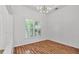 Bright, open living room featuring hardwood floors and large windows with plantation shutters at 2202 Hickory Ridge Dr, Valrico, FL 33596