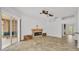 Bright living room with a stylish fireplace, tile floors, ceiling fans, and patio access at 2202 Hickory Ridge Dr, Valrico, FL 33596