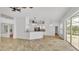 Open living area with tile floors, modern lighting, bar seating, and access to the outdoors at 2202 Hickory Ridge Dr, Valrico, FL 33596
