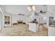 Spacious, open-concept living area with kitchen, fireplace, ceiling fans, and sliding glass doors at 2202 Hickory Ridge Dr, Valrico, FL 33596