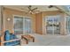 Covered outdoor patio area featuring ceiling fan, outdoor seating, and sliding glass doors at 2202 Hickory Ridge Dr, Valrico, FL 33596