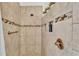 Close-up of tiled shower with recessed niche and bronze fixtures at 2202 Hickory Ridge Dr, Valrico, FL 33596