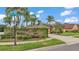 Street corner entrance to a community, with lots of trees and colorful shrubs at 2202 Hickory Ridge Dr, Valrico, FL 33596