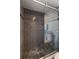 Stylish bathroom features pebble flooring in a walk-in shower enclosed by glass doors and neutral-toned tiles at 2584 58Th S Ave, St Petersburg, FL 33710