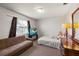 This bedroom features a cozy atmosphere with a couch, TV, and a large teddy bear on the bed at 2584 58Th S Ave, St Petersburg, FL 33710