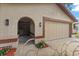 Home exterior showcasing a two-car garage, a arched entryway, and manicured landscaping at 2584 58Th S Ave, St Petersburg, FL 33710