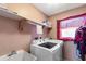Functional laundry room with modern washer and dryer units plus utility sink at 2584 58Th S Ave, St Petersburg, FL 33710
