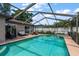 Screened-in pool and spa with lounge chairs surrounded by landscaped greenery, perfect for outdoor entertaining at 2584 58Th S Ave, St Petersburg, FL 33710