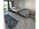 This bedroom boasts tons of natural light, tile floors, and a view of the community at 2625 State Road 590 # 1512, Clearwater, FL 33759