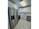 Modern kitchen features stainless steel appliances, and white cabinets at 2625 State Road 590 # 1512, Clearwater, FL 33759