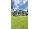 Spacious backyard featuring a screened patio, perfect for enjoying the outdoor scenery from home at 27312 Edenfield Dr, Wesley Chapel, FL 33544