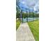 Community basketball court with a chain-link fence and blue and green painted surface, ready for play at 27312 Edenfield Dr, Wesley Chapel, FL 33544