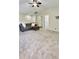 Spacious bonus room with a comfortable couch, carpeted floors, and a ceiling fan at 27312 Edenfield Dr, Wesley Chapel, FL 33544
