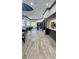 Spacious clubhouse interior featuring tile flooring, tables, chairs, and built-in shelving at 27312 Edenfield Dr, Wesley Chapel, FL 33544