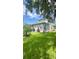 A charming exterior home view highlights a well-manicured lawn and peaceful backyard space at 27312 Edenfield Dr, Wesley Chapel, FL 33544