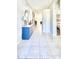 Long hallway with tile floors, leading to various rooms in the home at 27312 Edenfield Dr, Wesley Chapel, FL 33544