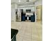 The kitchen features stainless steel appliances and cabinets, with white upper cabinets and blue lower cabinets at 27312 Edenfield Dr, Wesley Chapel, FL 33544