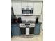 A stainless steel oven is surrounded by sleek, navy blue cabinets, with modern subway tile and elegant granite countertops at 27312 Edenfield Dr, Wesley Chapel, FL 33544