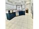 Spacious kitchen with dark blue cabinets, stainless steel appliances, light countertops, and tile flooring at 27312 Edenfield Dr, Wesley Chapel, FL 33544