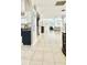 Open concept living area with tile flooring, a kitchen, and a cozy living room at 27312 Edenfield Dr, Wesley Chapel, FL 33544