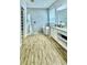 The main bathroom features wood-look tile, a walk-in shower, and a soaking tub at 27312 Edenfield Dr, Wesley Chapel, FL 33544