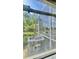 View of the screened patio and the air conditioning unit at 27312 Edenfield Dr, Wesley Chapel, FL 33544