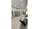 Modern restroom featuring multiple sinks, granite countertops, and tiled walls at 27312 Edenfield Dr, Wesley Chapel, FL 33544