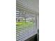 Scenic window view of a lush lawn and tranquil lake at 27312 Edenfield Dr, Wesley Chapel, FL 33544
