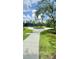 Beautiful walking path with lush landscaping and mature trees in a well-maintained community at 27312 Edenfield Dr, Wesley Chapel, FL 33544