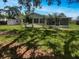 View of the backyard with a storage shed and an enclosed patio at 2908 Lockwood Meadows Blvd, Sarasota, FL 34234