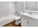 Bathroom featuring a shower-tub combo, toilet, and vanity with white sink and white tiled wall at 2908 Lockwood Meadows Blvd, Sarasota, FL 34234