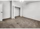 Spacious bedroom with neutral walls, plush carpeting, and double-door closet; with a view to the attached bathroom at 2908 Lockwood Meadows Blvd, Sarasota, FL 34234