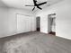 Spacious bedroom with plush carpeting, a ceiling fan, large closet and door to an attached bathroom at 2908 Lockwood Meadows Blvd, Sarasota, FL 34234