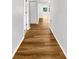 Hallway featuring hardwood flooring, white walls, and doorways with white frames at 2908 Lockwood Meadows Blvd, Sarasota, FL 34234