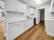 Well-lit kitchen featuring white cabinets, modern countertops, and stainless steel appliances at 2908 Lockwood Meadows Blvd, Sarasota, FL 34234