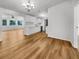 Open-concept kitchen with white cabinets, modern appliances, and wood-look flooring, and connected living space at 2908 Lockwood Meadows Blvd, Sarasota, FL 34234