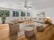 Bright and spacious living room featuring ample seating, a ceiling fan, and natural light from the windows at 2908 Lockwood Meadows Blvd, Sarasota, FL 34234