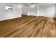Open-concept living area with wood-look floors, ceiling fan, and neutral walls at 2908 Lockwood Meadows Blvd, Sarasota, FL 34234