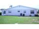 Spacious backyard featuring manicured lawn, and property side at 402 Dorchester Pl # 44, Sun City Center, FL 33573