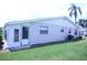 Spacious backyard featuring manicured lawn, and a sunroom with lots of windows at 402 Dorchester Pl # 44, Sun City Center, FL 33573