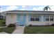 Charming single-story home with a light blue door, shutters, and well-manicured front yard at 402 Dorchester Pl # 44, Sun City Center, FL 33573