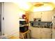 This kitchen features white cabinetry and updated appliances at 402 Dorchester Pl # 44, Sun City Center, FL 33573