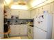 Efficient kitchen with white cabinetry and ample countertop space at 402 Dorchester Pl # 44, Sun City Center, FL 33573