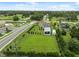 Home with a pool, carport, and landscaping bordering commercial property at 40449 Trotter Ln, Dade City, FL 33525